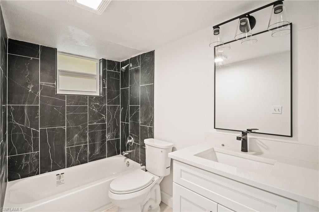Full bath with vanity and shower / bath combination