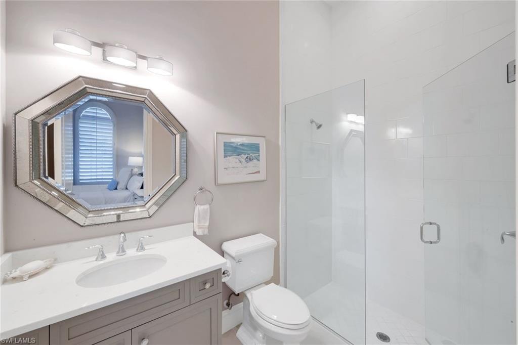 Full bath featuring a stall shower, vanity, and ensuite bath