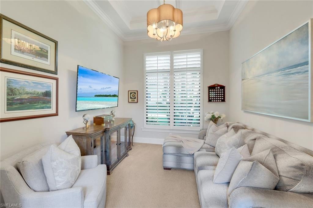 Den or Office Area crown molding, a chandelier, carpet floors, and a raised ceiling