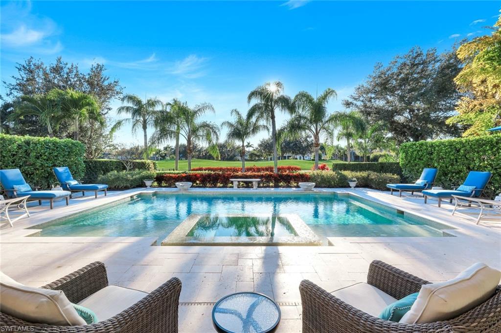 Stunning golf & pool views featuring a patio and a pool with connected hot tub