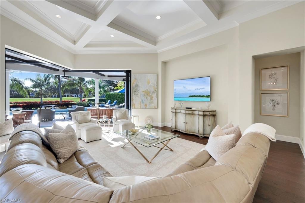 Great Room open to lanai, coffered ceiling, wood finished floors, and crown molding