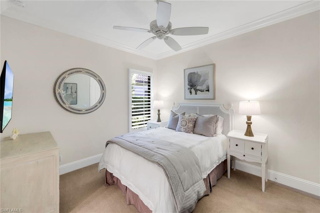 3nd Bedroom with Queen Bed light colored carpet, ceiling fan, and crown molding