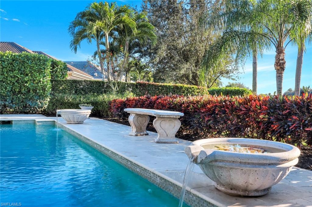 View of pool with a patio and an outdoor fire pit
