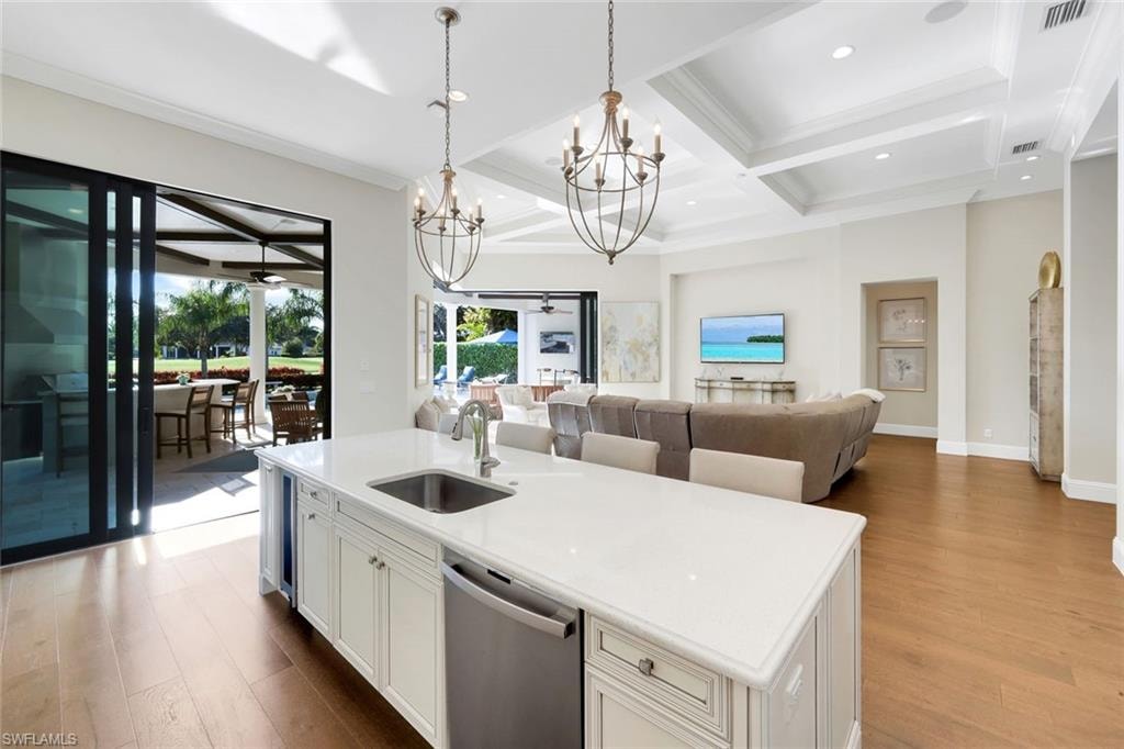 Kitchen featuring white cabinets, dishwasher, open floor plan, dark wood-style floors, and coffered ceiling