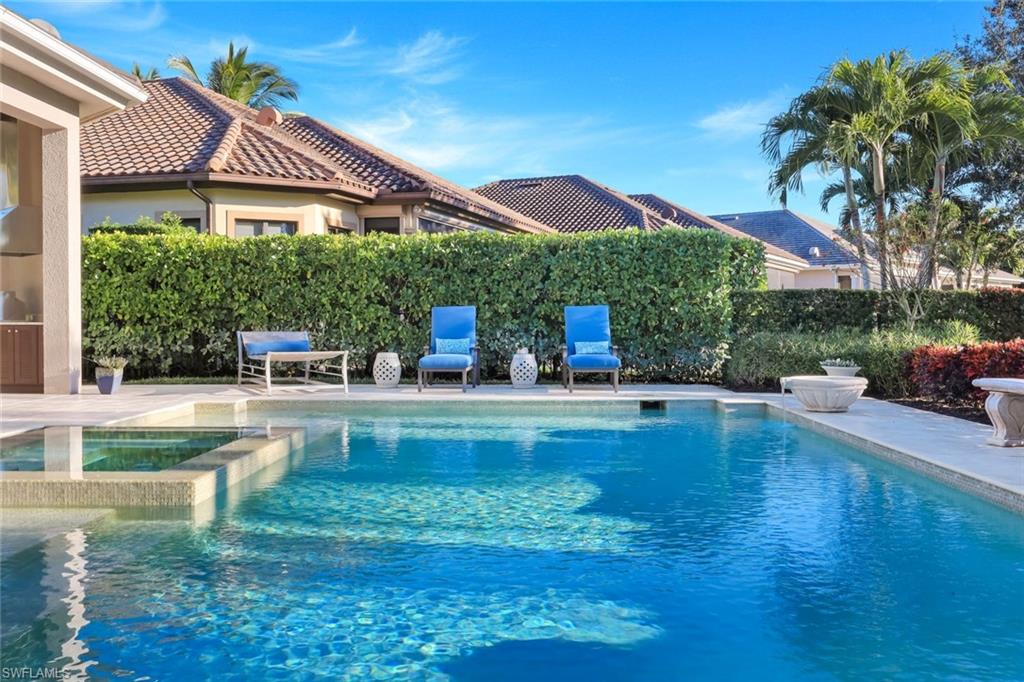 View of swimming pool with a patio area and a pool with connected hot tub
