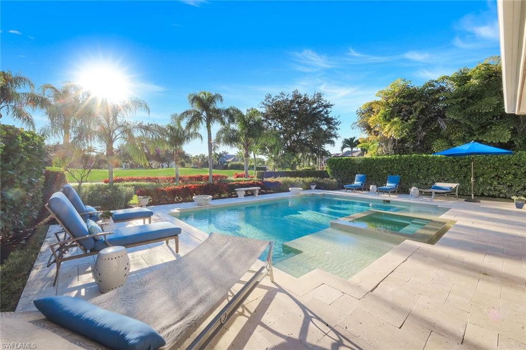 View of swimming pool with a patio and a pool with connected hot tub