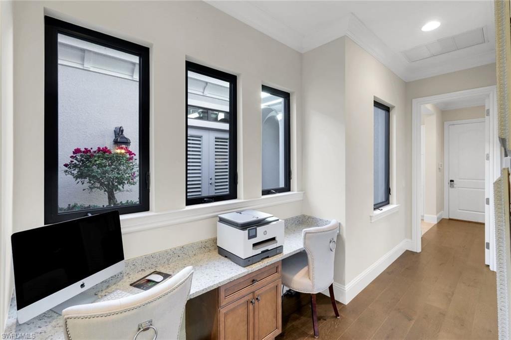 Office with built in desk, dark wood-style floor, crown molding, and recessed lighting