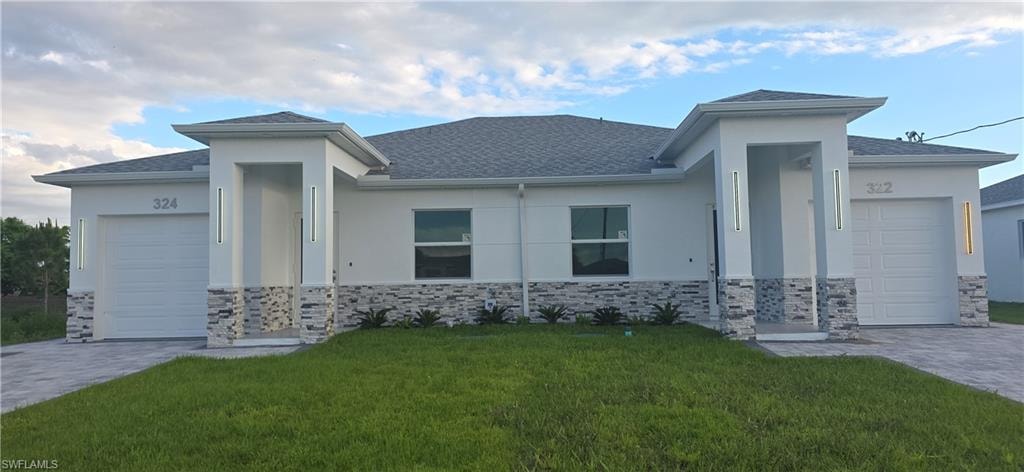 Contemporary duplex exterior featuring white stucco, stacked stone accents, and a shingle roof