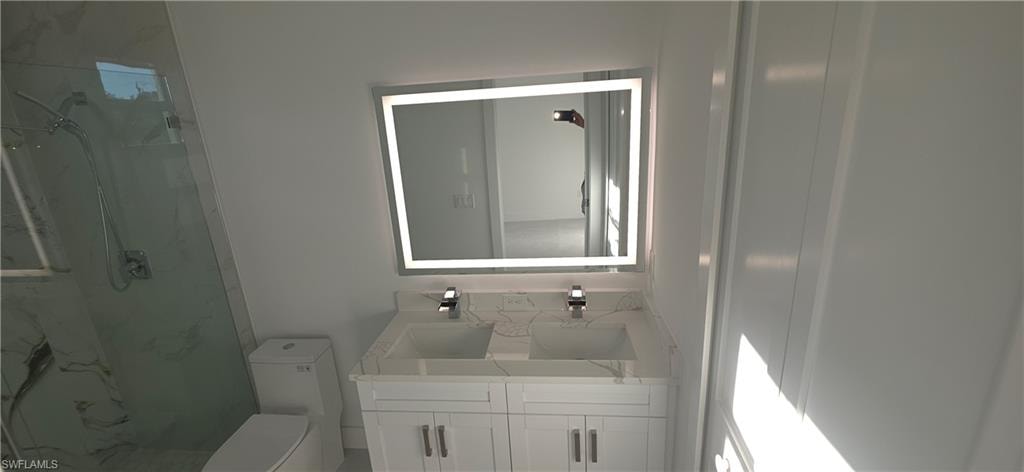 Contemporary vanity with dual integrated sinks and polished chrome fixtures