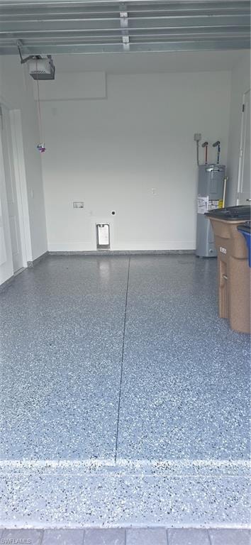 Spacious garage featuring a durable flake epoxy flooring, white painted walls, and an automatic garage door opener