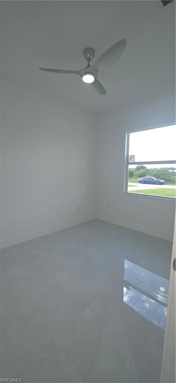 Room featuring light gray tile flooring, a modern ceiling fan with integrated lighting, a white painted wall finish, and a window with a white frame