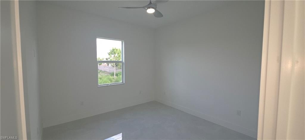 Interior room featuring light-toned flooring, white walls, and a contemporary ceiling fan with integrated lighting