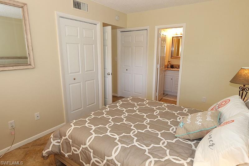 Bedroom with tile flooring and ensuite bathroom