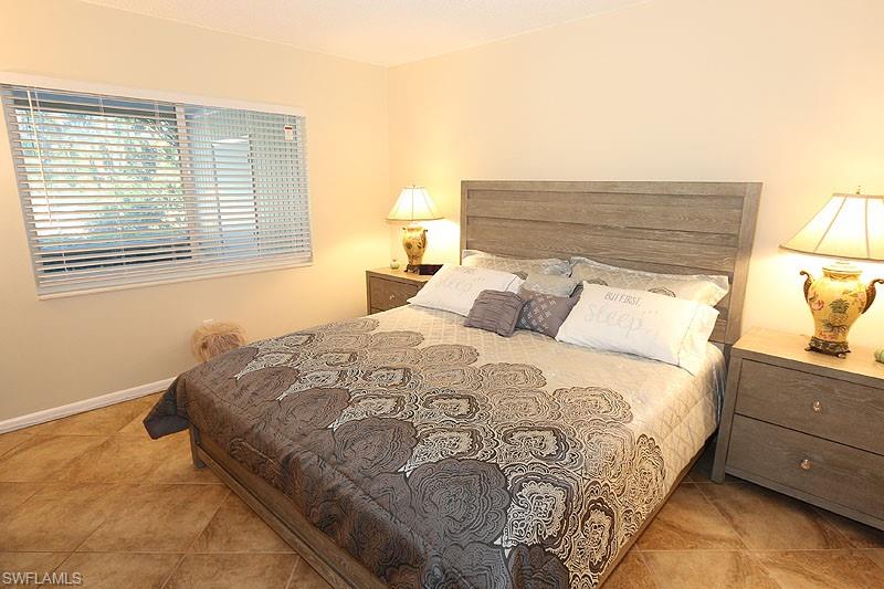 Bedroom with light tile floors