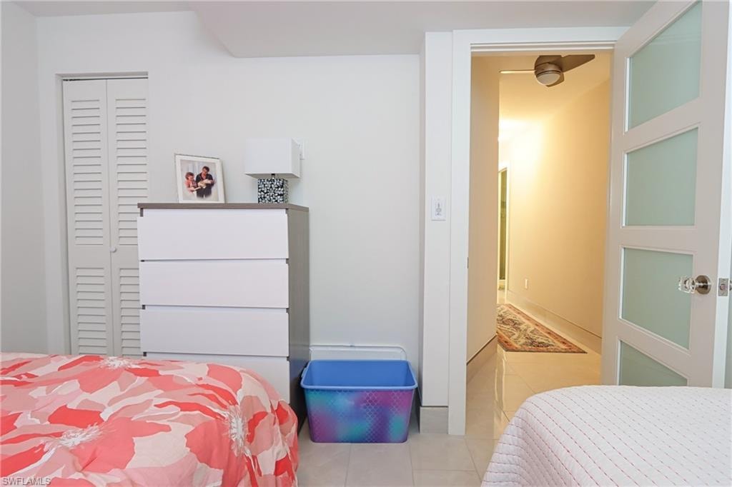 Bedroom featuring a closet and light tile flooring