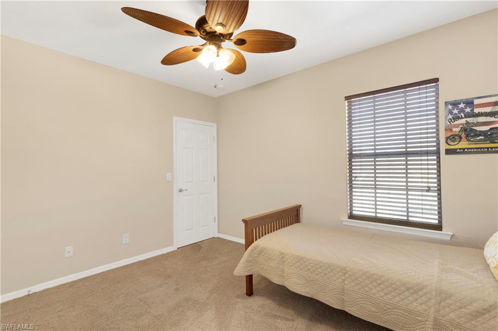Bedroom with light colored carpet and ceiling fan
