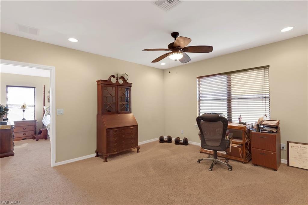 Office featuring a wealth of natural light, light colored carpet, and ceiling fan