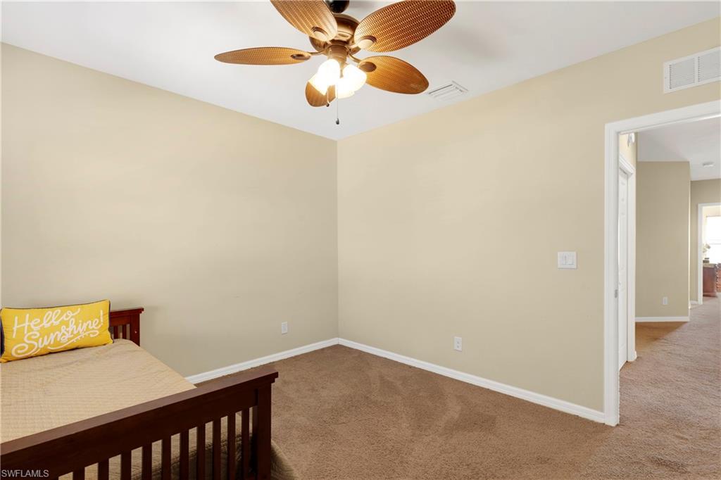 Bedroom with ceiling fan and carpet flooring