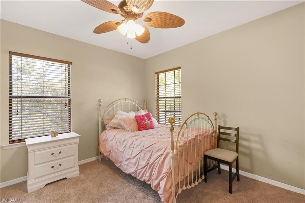 Bedroom featuring light colored carpet and ceiling fan