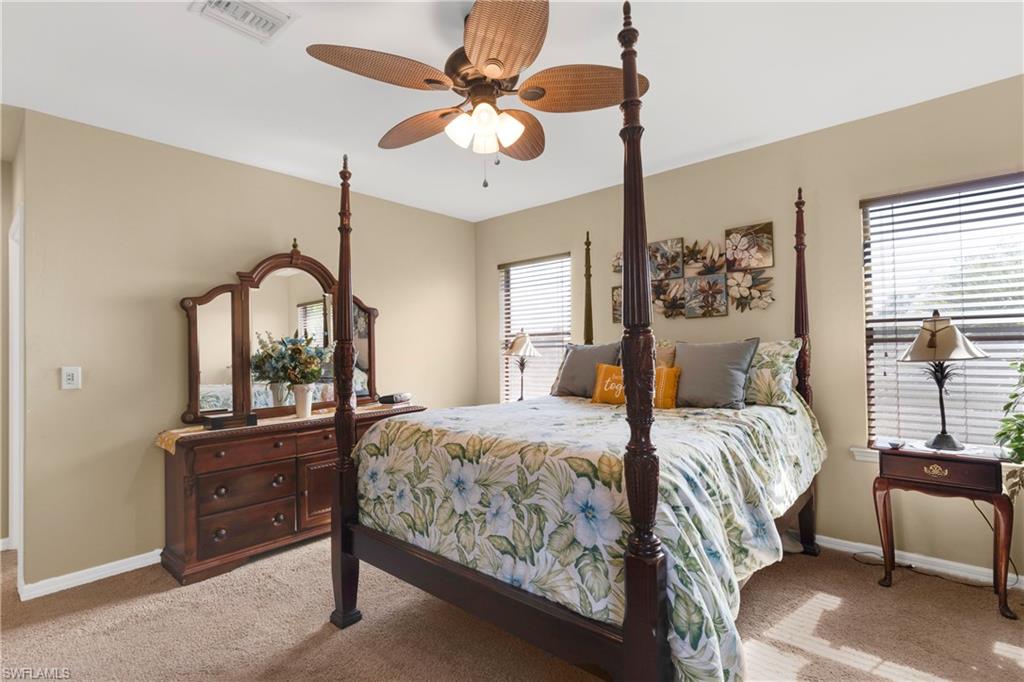 Carpeted bedroom with ceiling fan