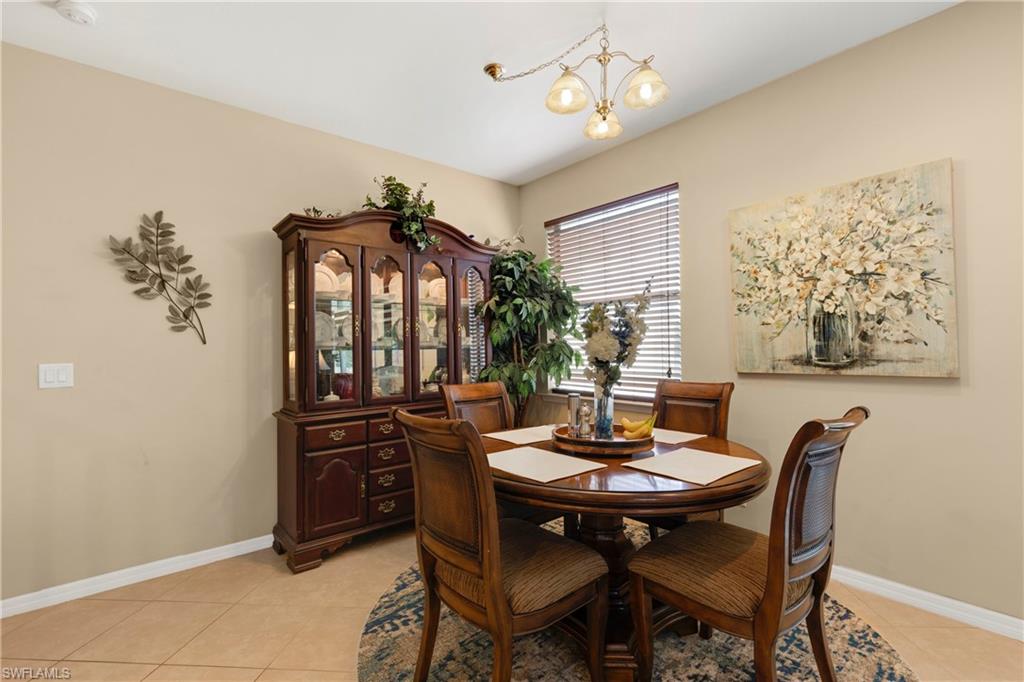 Dining room featuring a chandelier and light tile patterned flooring