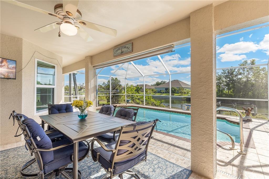Covered Lanai with table for six, mounted television and roll down sun screen.