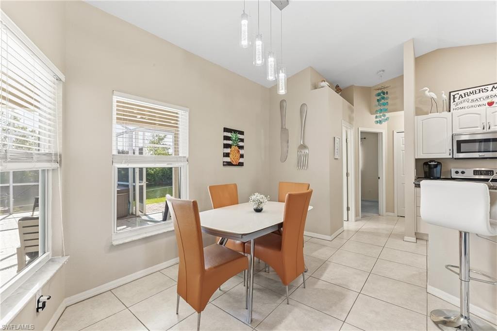 Contemporary fixtures and table with views of pool & canal.