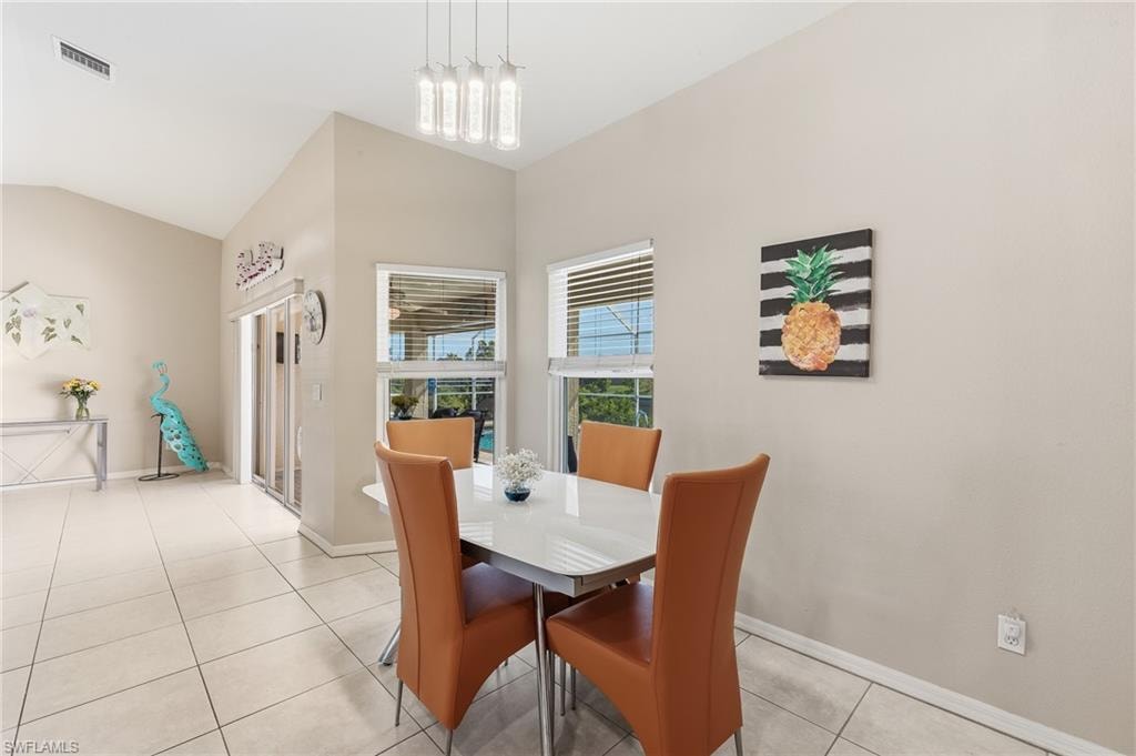 Contemporary fixtures and table with views of pool & canal.