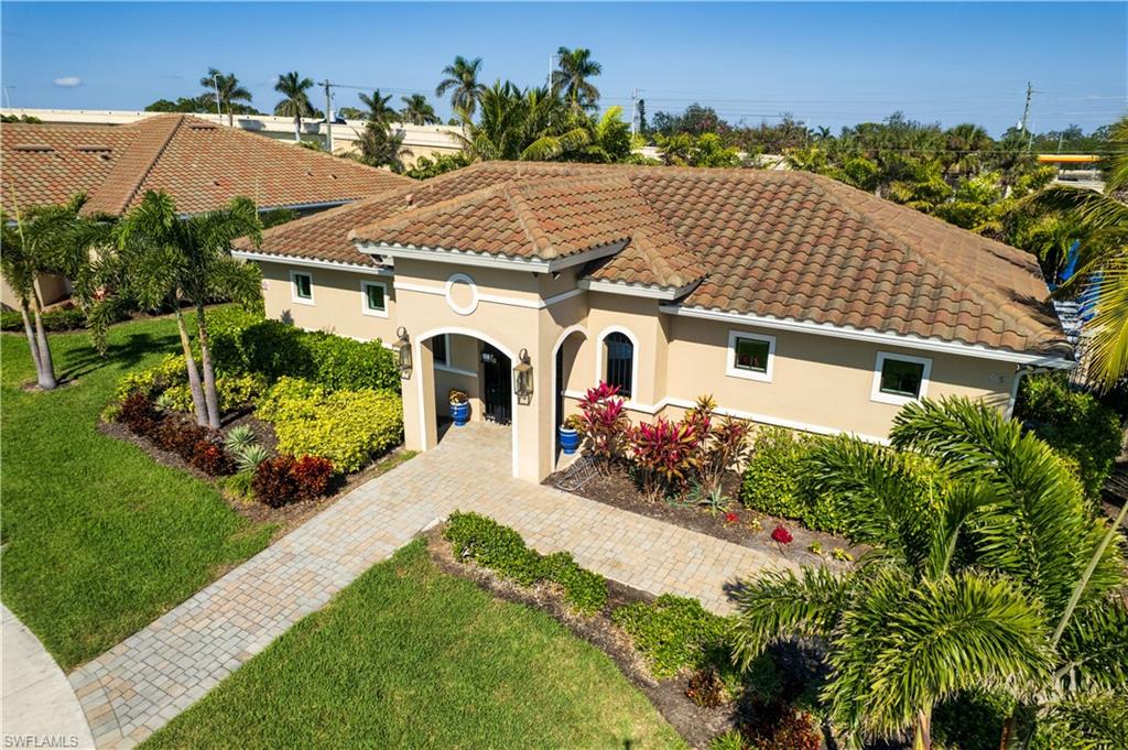 Mediterranean-style residence featuring a tile roof and stucco exterior