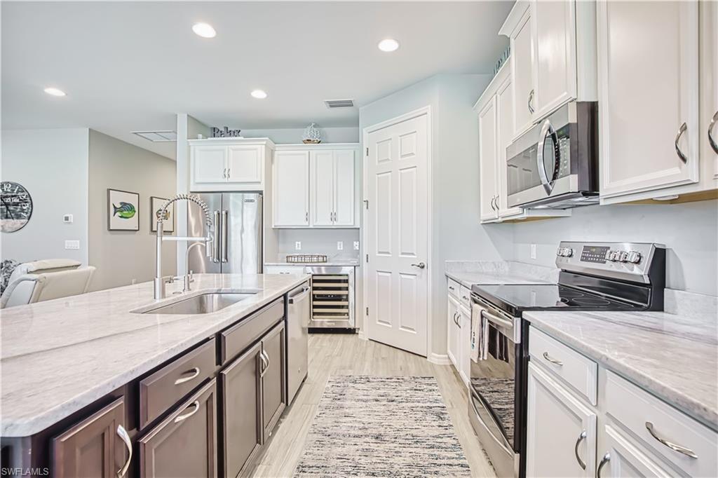 Wine refrigerator, stainless steel appliances, island
