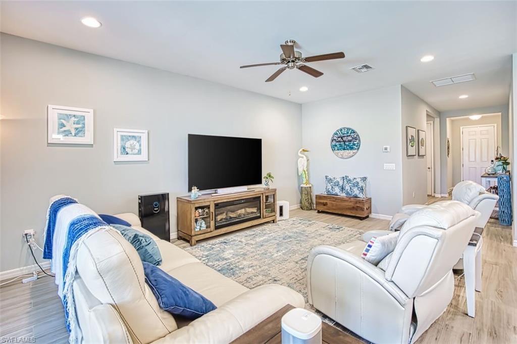 Open concept living space featuring recessed lighting, a ceiling fan, and wood-finish flooring