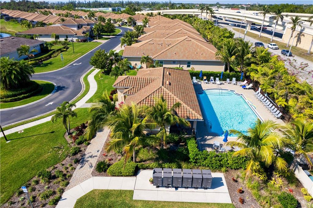 Community amenity area featuring a large swimming pool with surrounding lounge seating