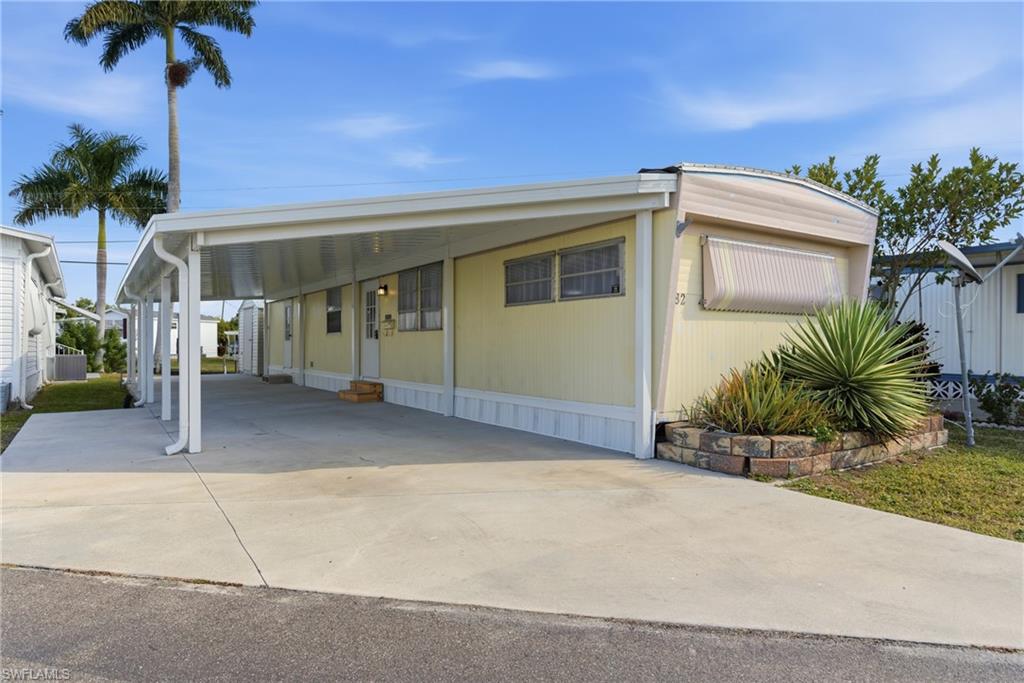 Manufactured / mobile home with a carport and driveway