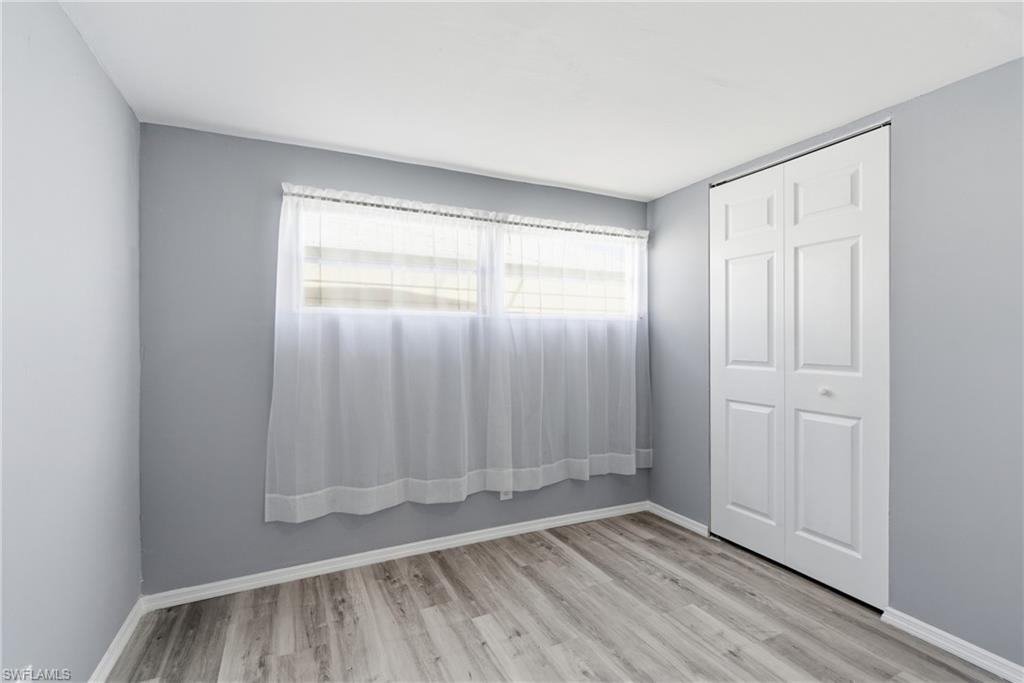 Unfurnished bedroom with a closet and light wood-style flooring