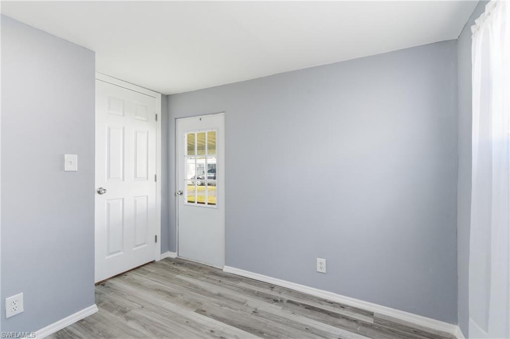Unfurnished bedroom with light wood-style flooring and baseboards