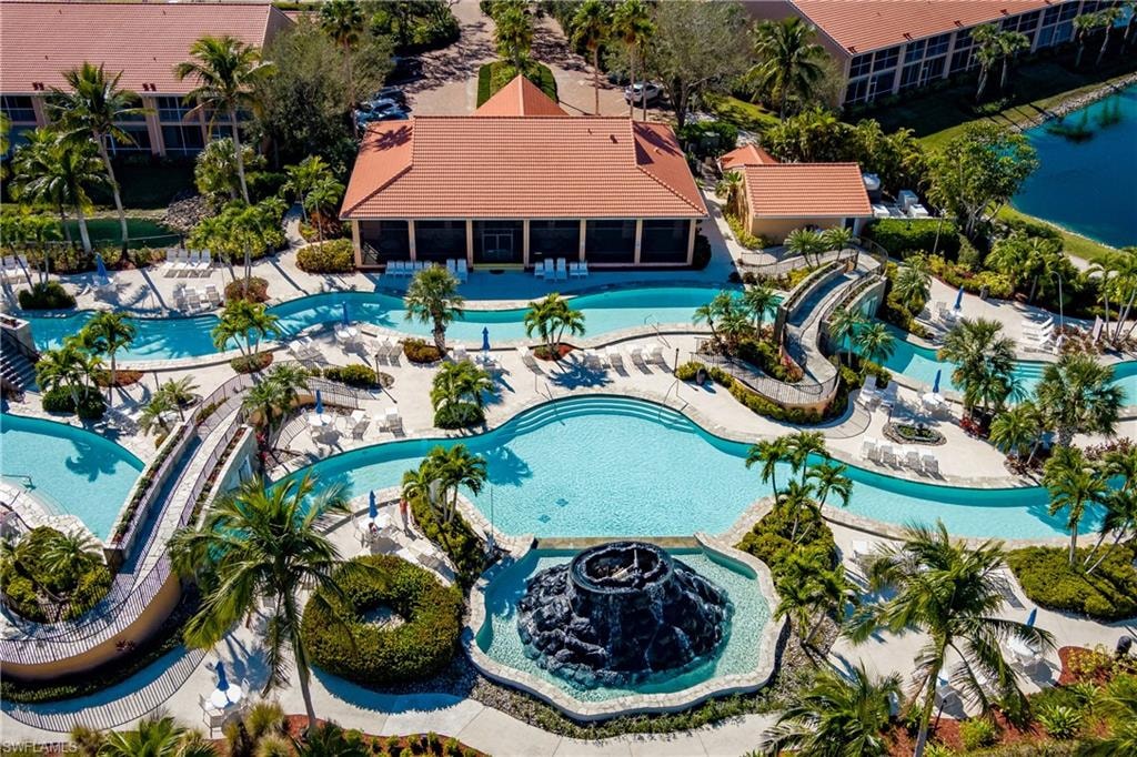 Resort-style pool complex featuring a central pool, winding lazy river, and rock formation water feature