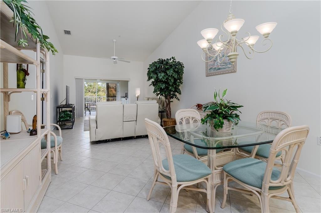 Vaulted ceiling enhances this open living space featuring ceramic tile flooring