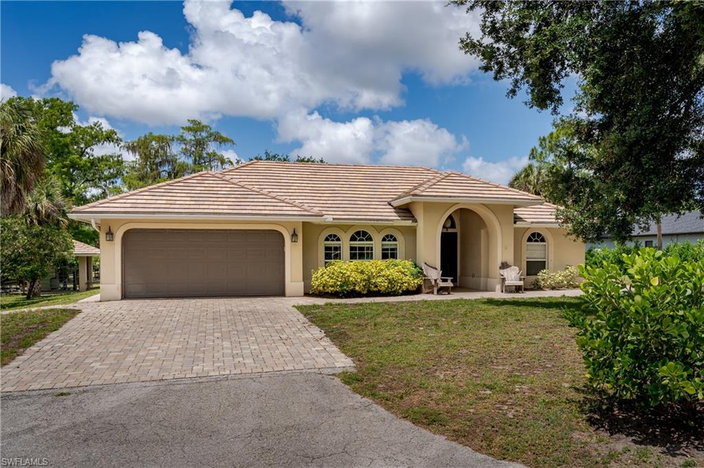 Mediterranean-style exterior featuring a tile roof and stucco siding