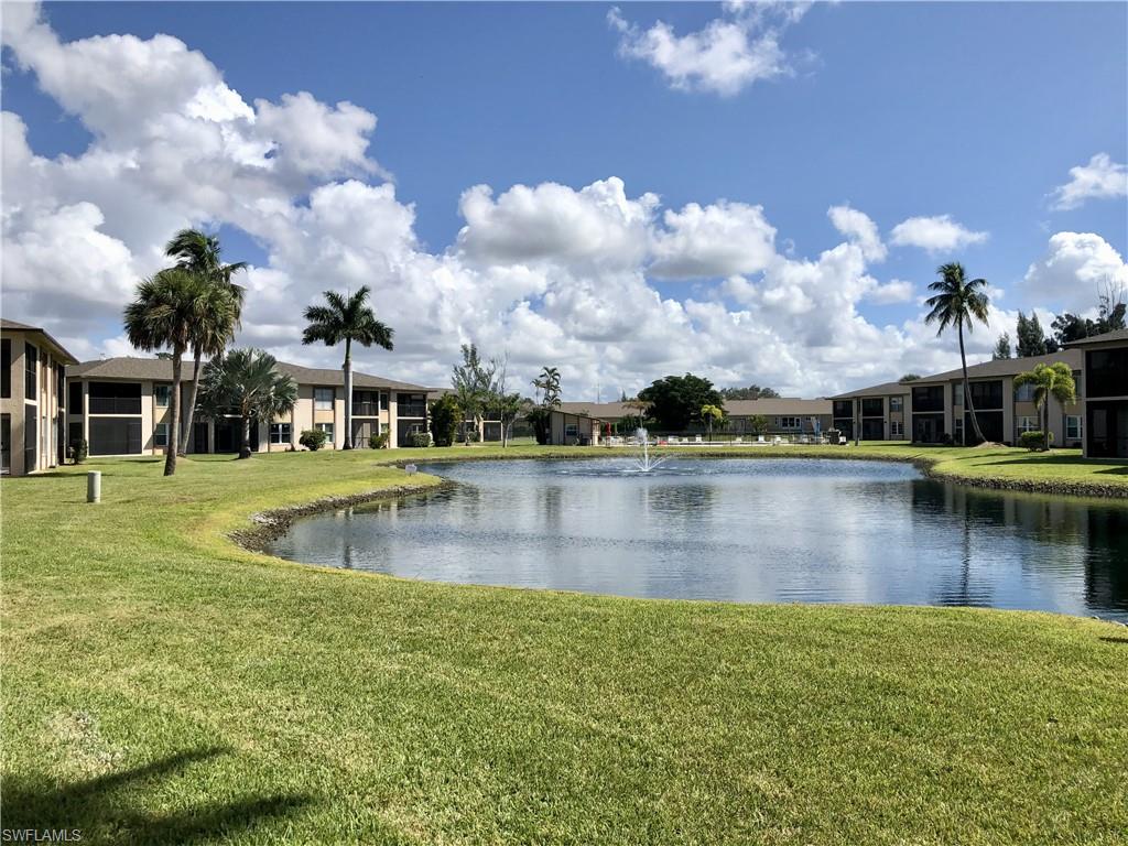 Expansive lawn surrounding a tranquil lake with a central fountain