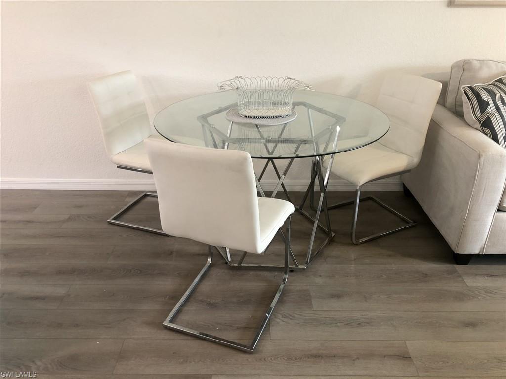 Wood-finish flooring with white baseboards throughout