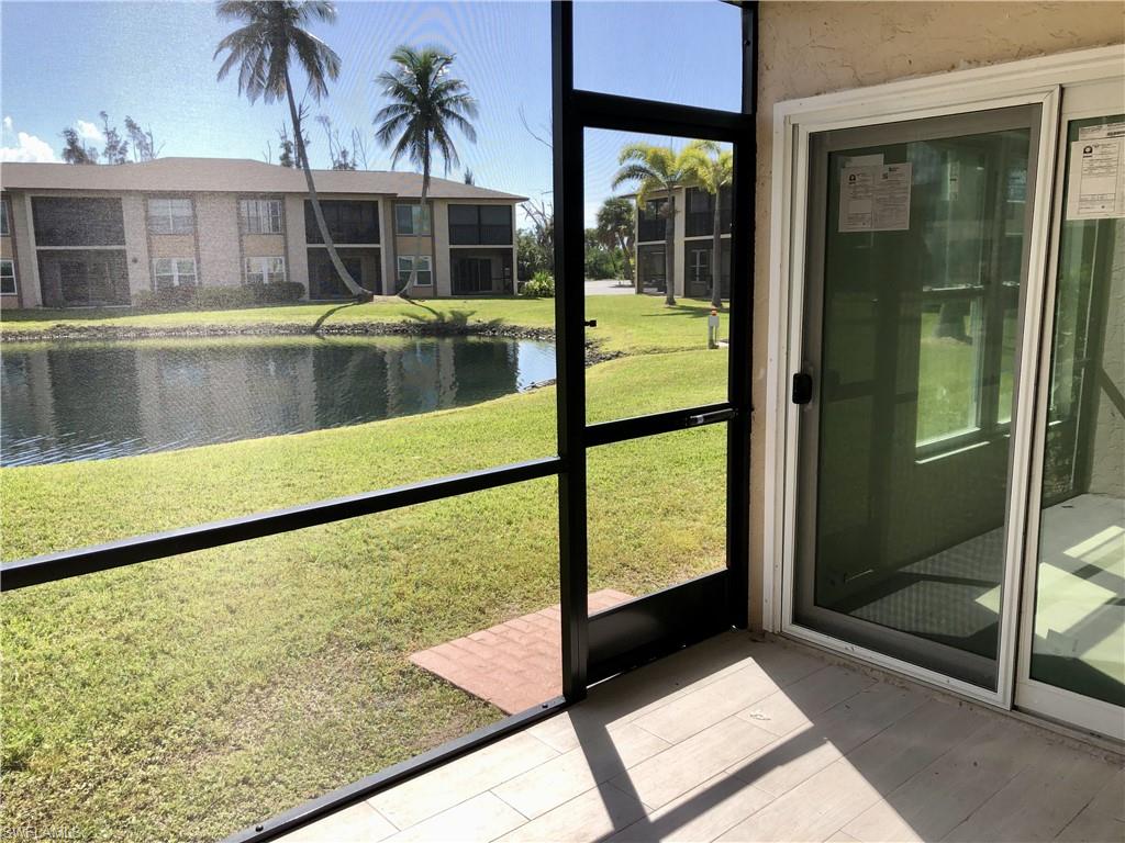 Screened patio with wood-finish tile flooring and sliding glass door access