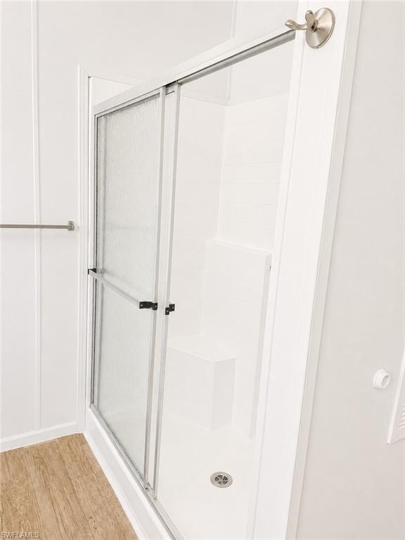 White walk-in shower with sliding frosted glass door