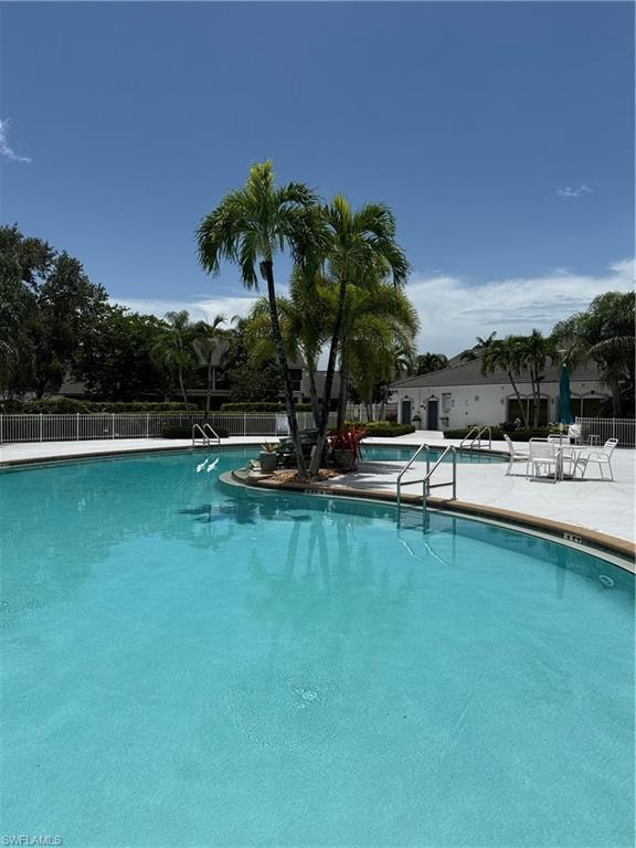 Community pool featuring a patio