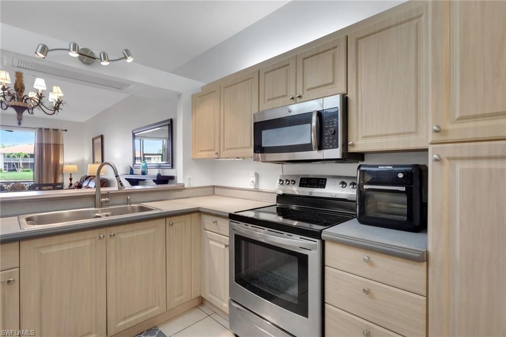 Kitchen with upper and lower cabinet lighting and stylish light fixture