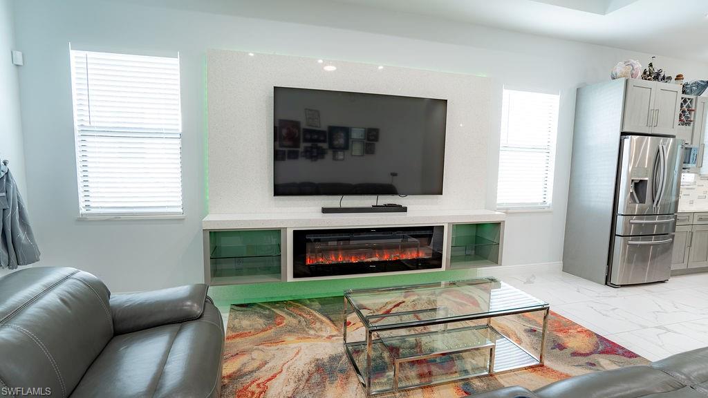 Integrated wall unit featuring an electric fireplace and accent lighting
