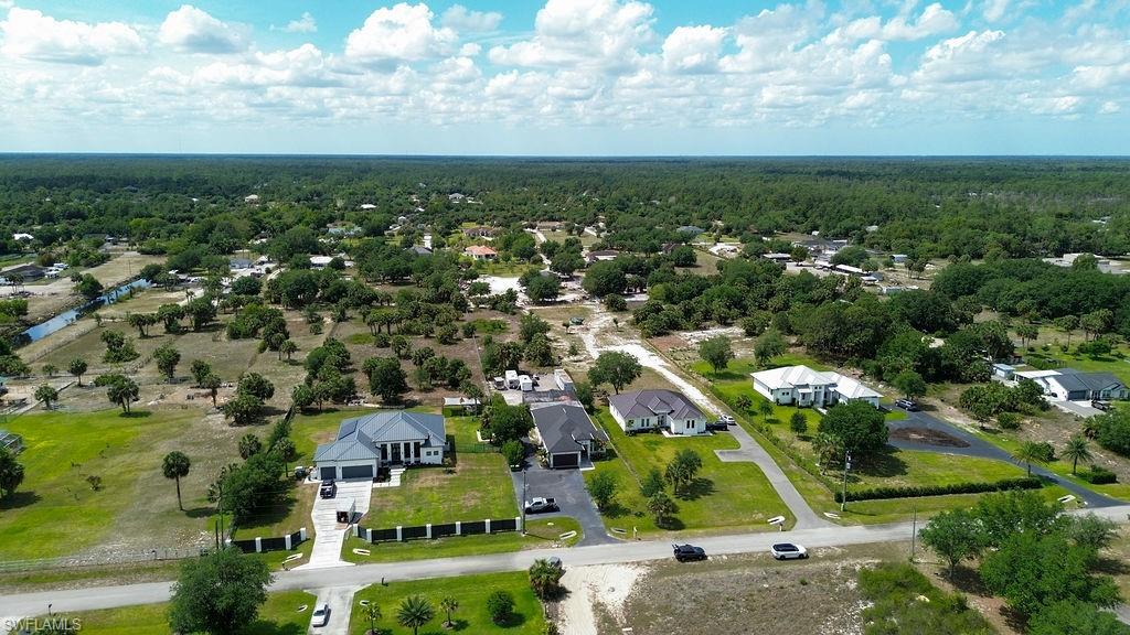 Expansive aerial view showcasing residential properties amidst a verdant landscape