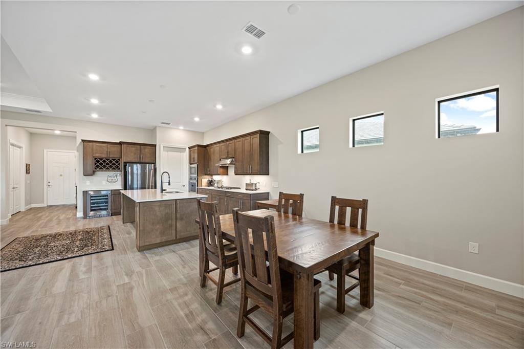 Dining area featuring recessed lighting, wood finish floors, and wine cooler