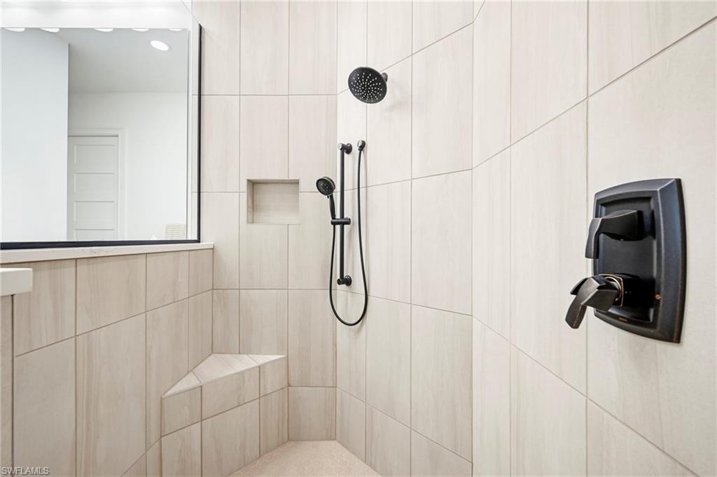 Shower enclosure with light-toned rectangular tilework