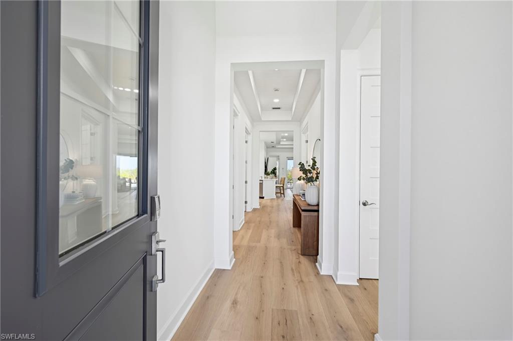 Entry foyer featuring a dark gray paneled door with glass inserts and dark hardware