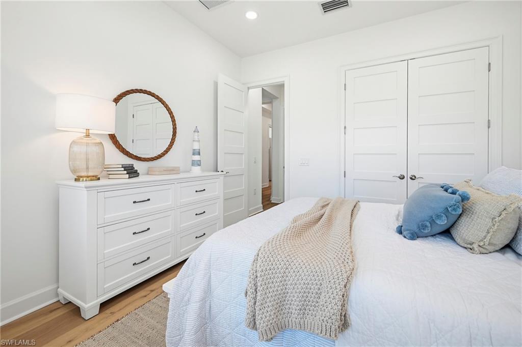 Bright interior room featuring wood-finish flooring and a white color palette